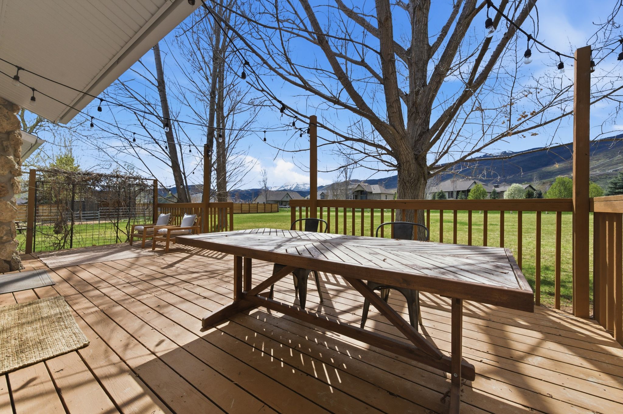 Covered back deck with picnic table looking toward the Wasatch